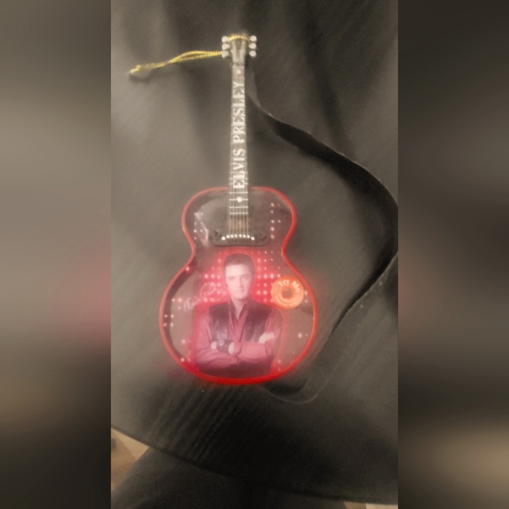 A authentic Elvis mini guitar that plays houndog.